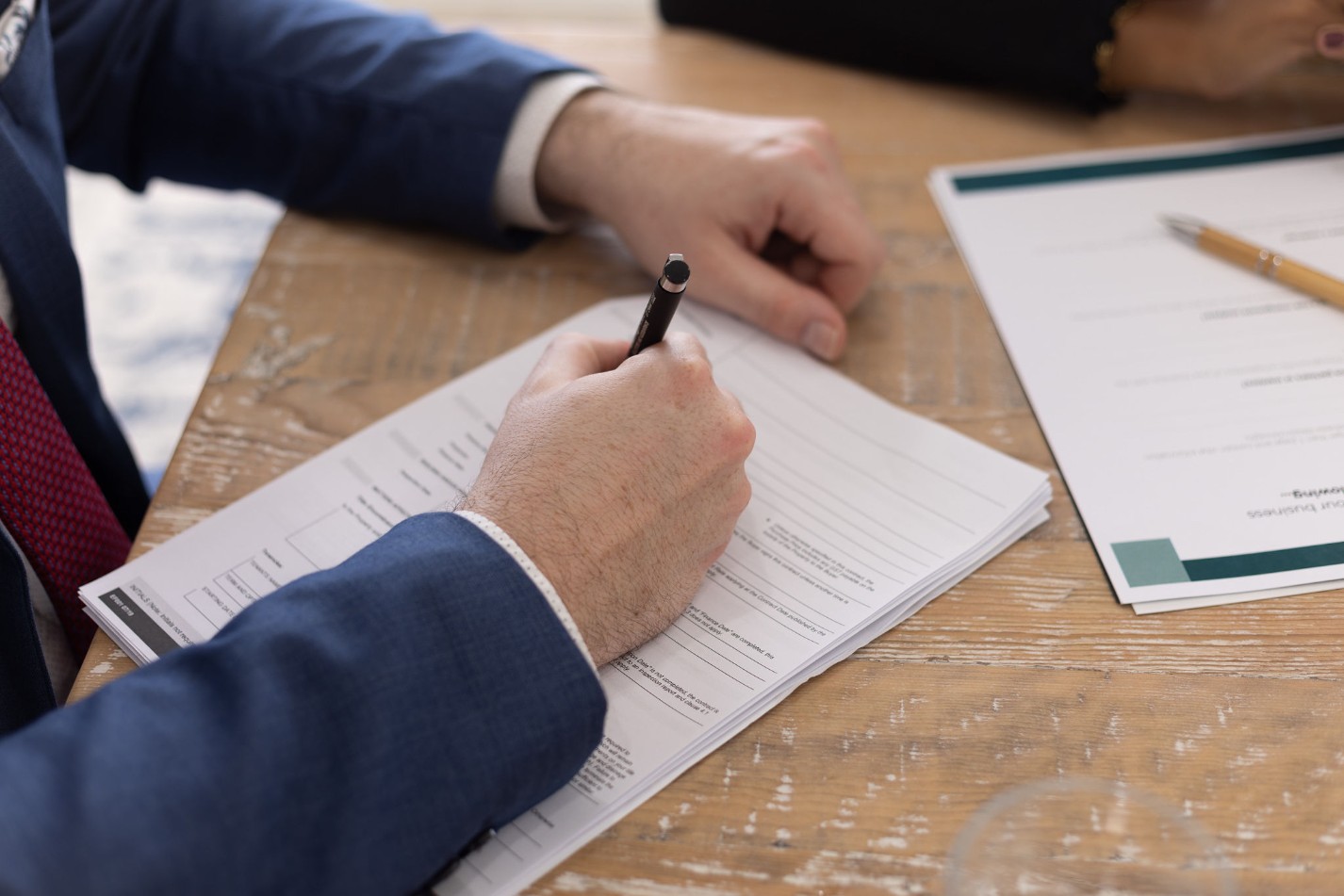 Hands writing on a document
