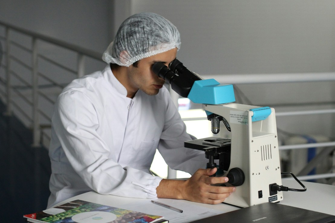 who-owns-frozen-embryos-divorce Lab technician inspecting sample in microscope
