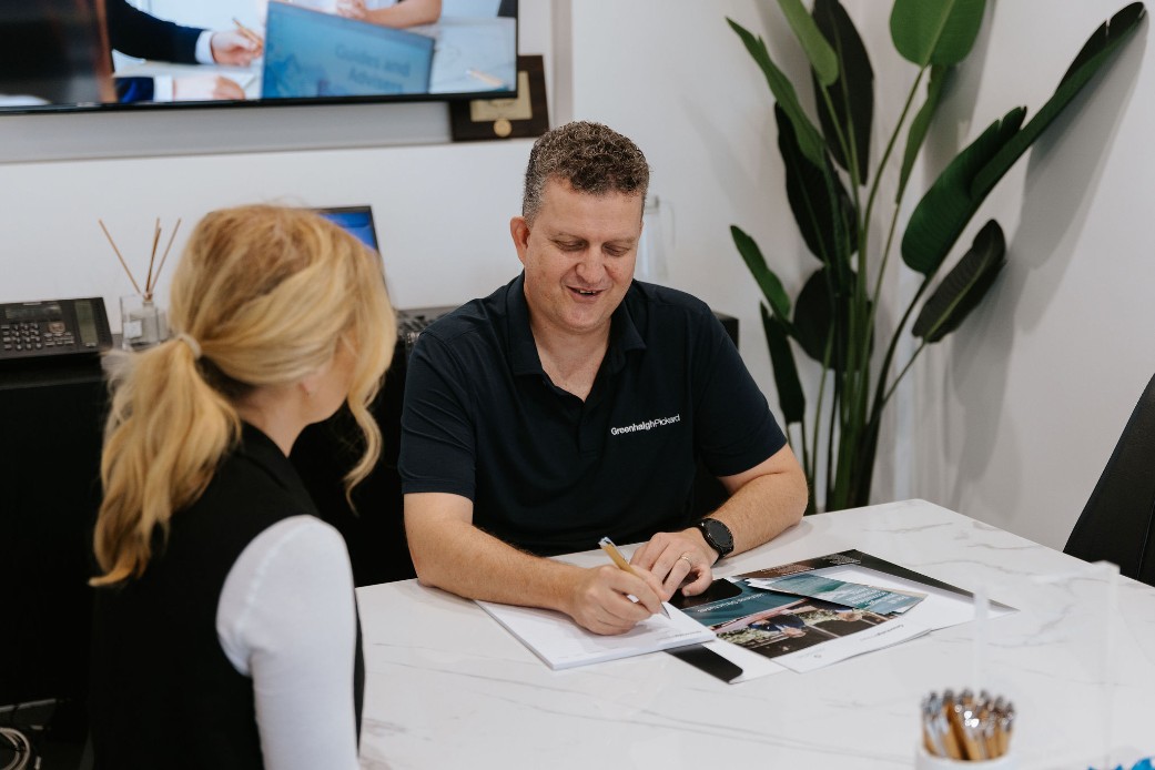 Older male accountant explaining taxes to blond female