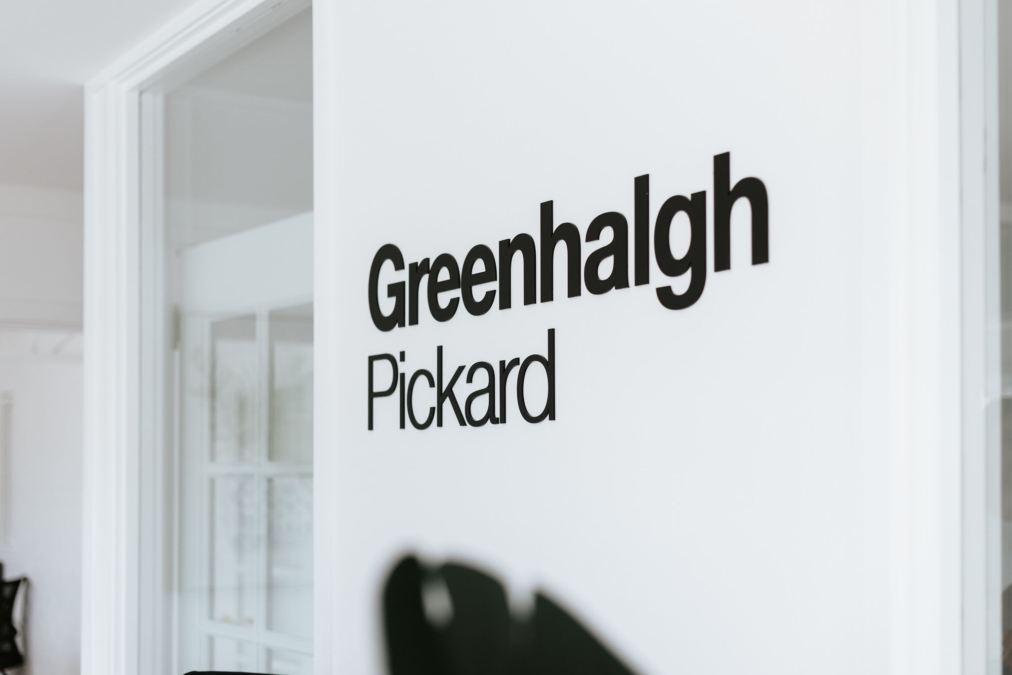 White wall with words greenhalgh pickard written on it