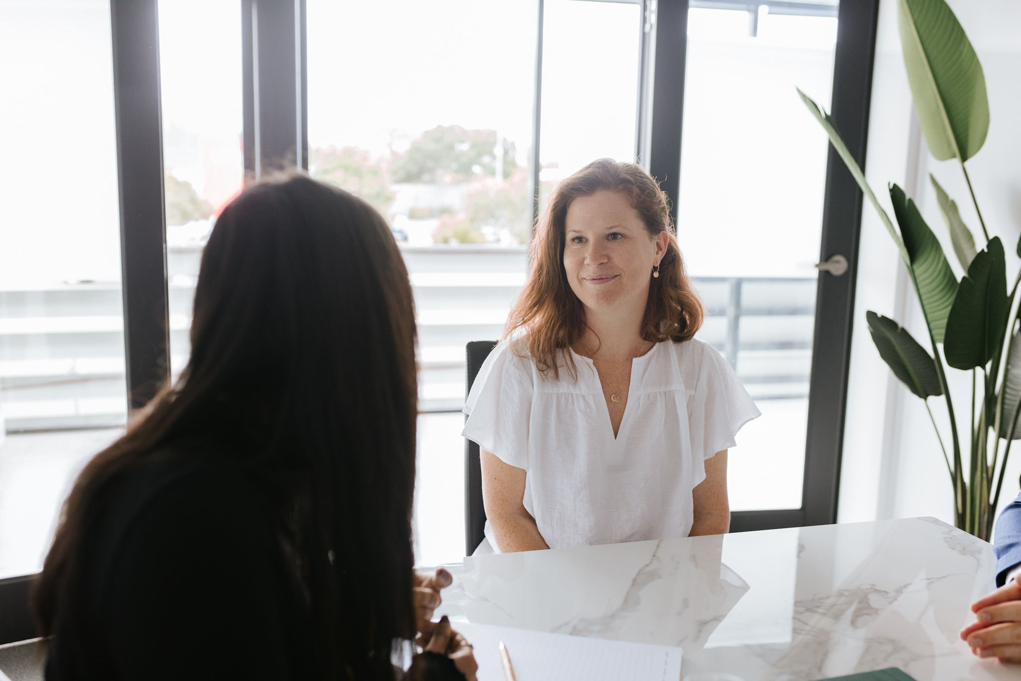 Red-haired female smiling at will solicitor